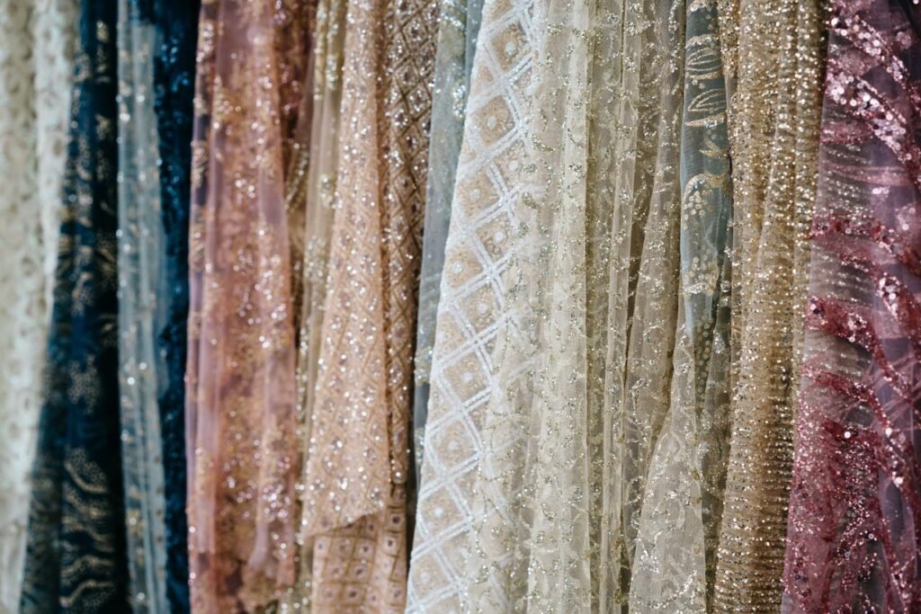 Close-up view of luxurious fabrics with intricate textures and shimmering details, ideal for fashion and design concepts.